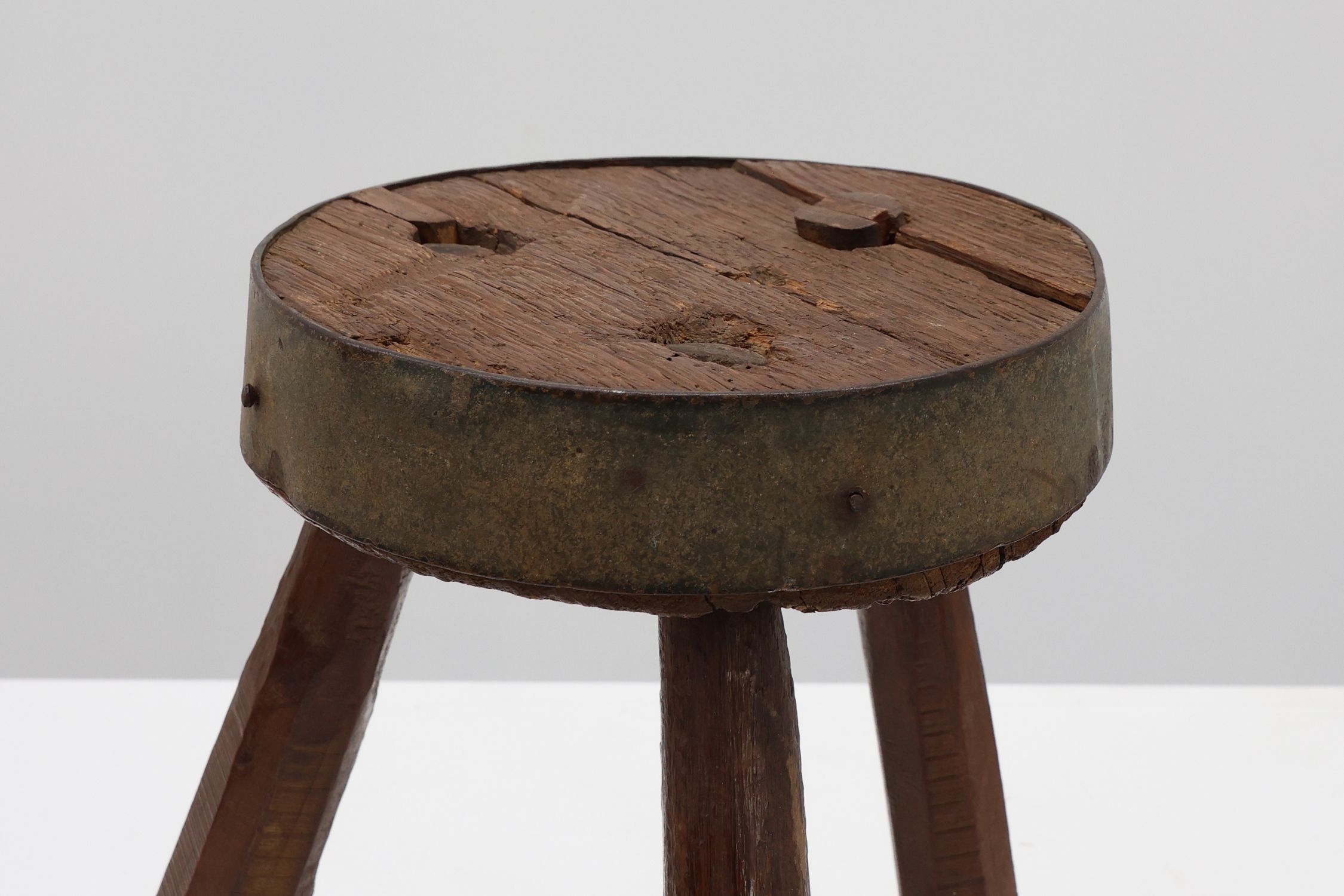 Brutalist French 1850s solid oak tripod stools with metal rim, set of 4thumbnail